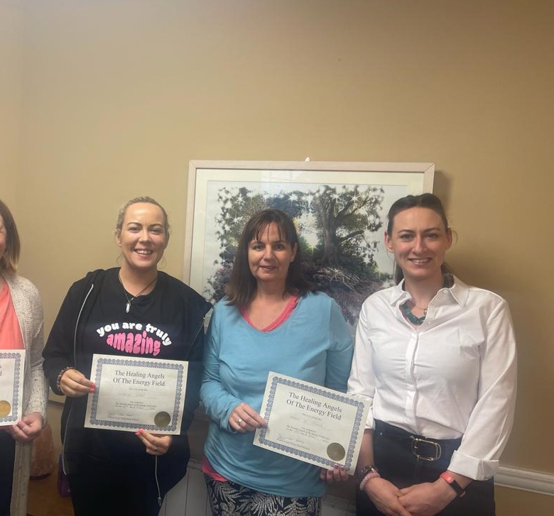Participants proudly displaying Healing Angels Workshop certificates in Dublin